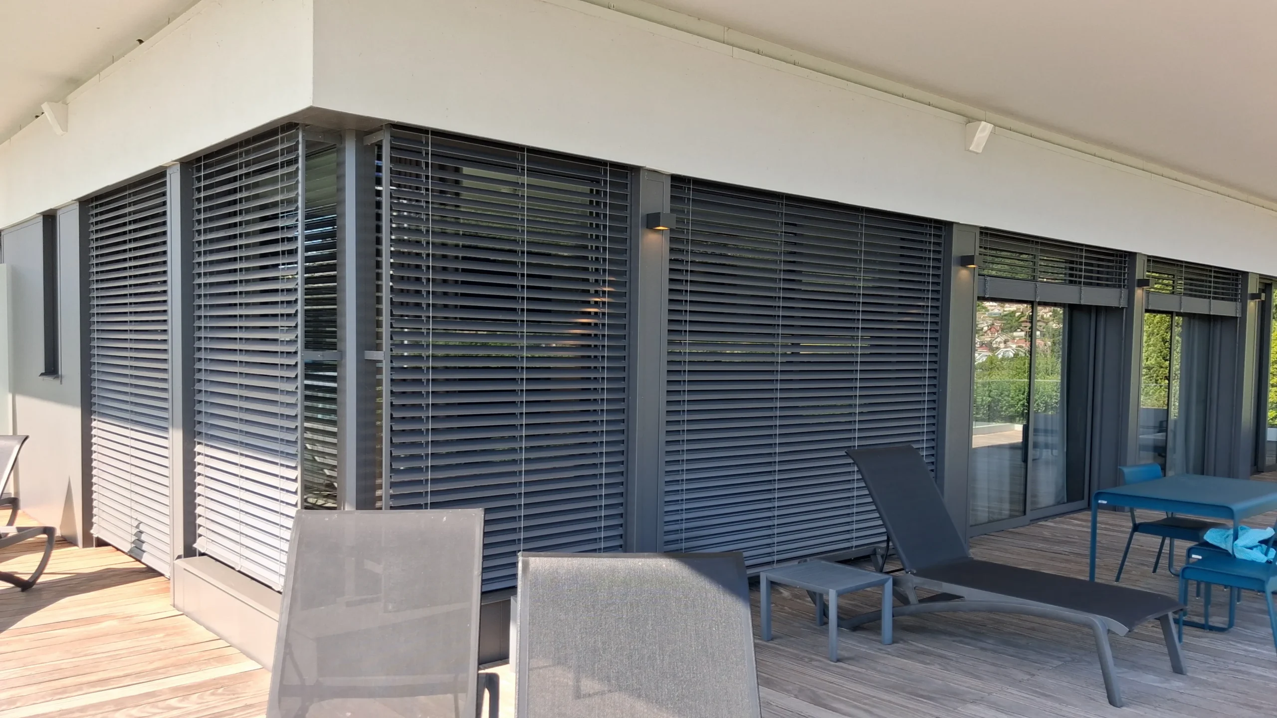 Brise-soleil orientable BSO aluminium sur une façade vitrée